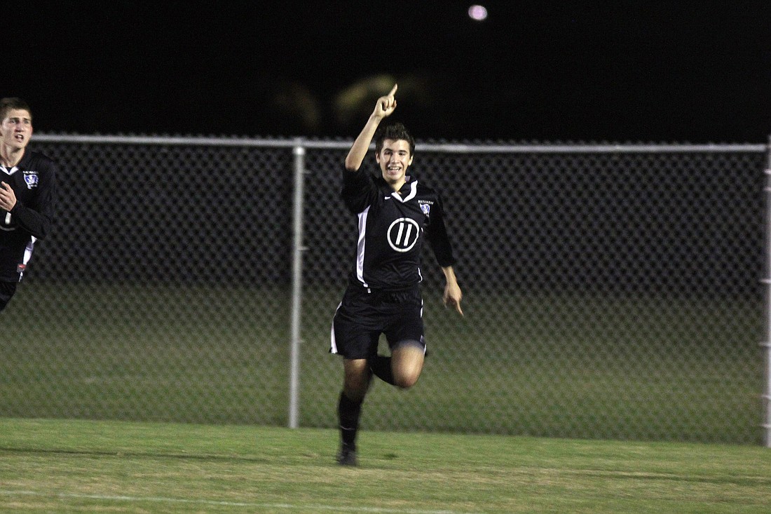 Dakotah Casale celebrates after scoring a goal in the second half. He also scored the overtime goal to win the game. PHOTO BY SHANNA FORTIER