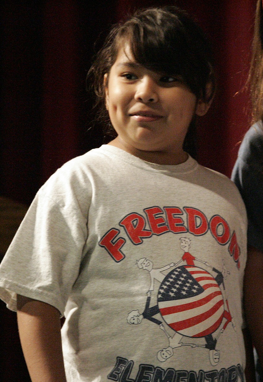 Seven-year-old Kaitlyn Delgadillo helped lead the students in singing 