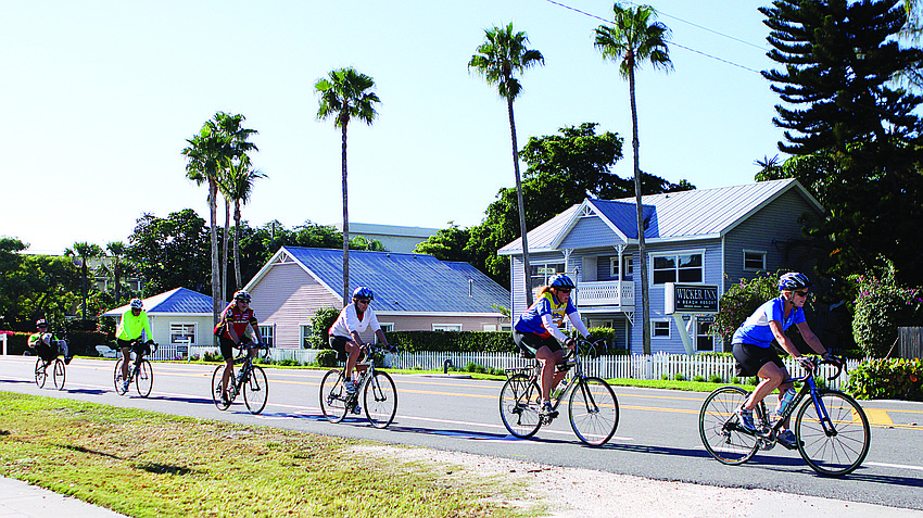 A group of bicyclers gets exercise in early with a group ride up and down Gulf of Mexico Drive the morning of Nov. 15.