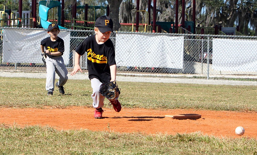Ryan Wirt, No. 5 for the pirates, goes to get a ground ball as Royce Sprinkle, No. 8, gets himself ready incase he is needed for back up.