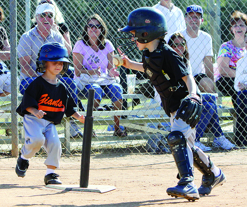 Giants' player Caleb Rumble tries to outrun Pirates' catcher Jameson Syprett to home plate during the final T-ball game of the season Saturday, Nov. 13, at Twin Lakes Park.