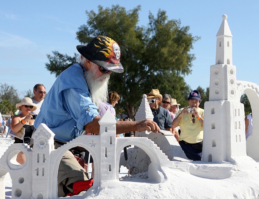 Amazin' Walter McDonald does some detail work on the sand sculpture he and William Lloyd created during the competition.