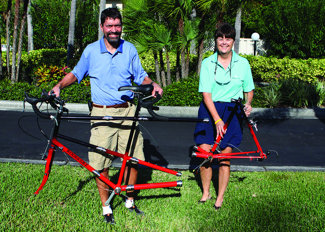 Steve and Penny Koerner pose with their tandem bicycle that they have already begun to take apart to put into two suitcases to take home to Colorado Springs, Colo.