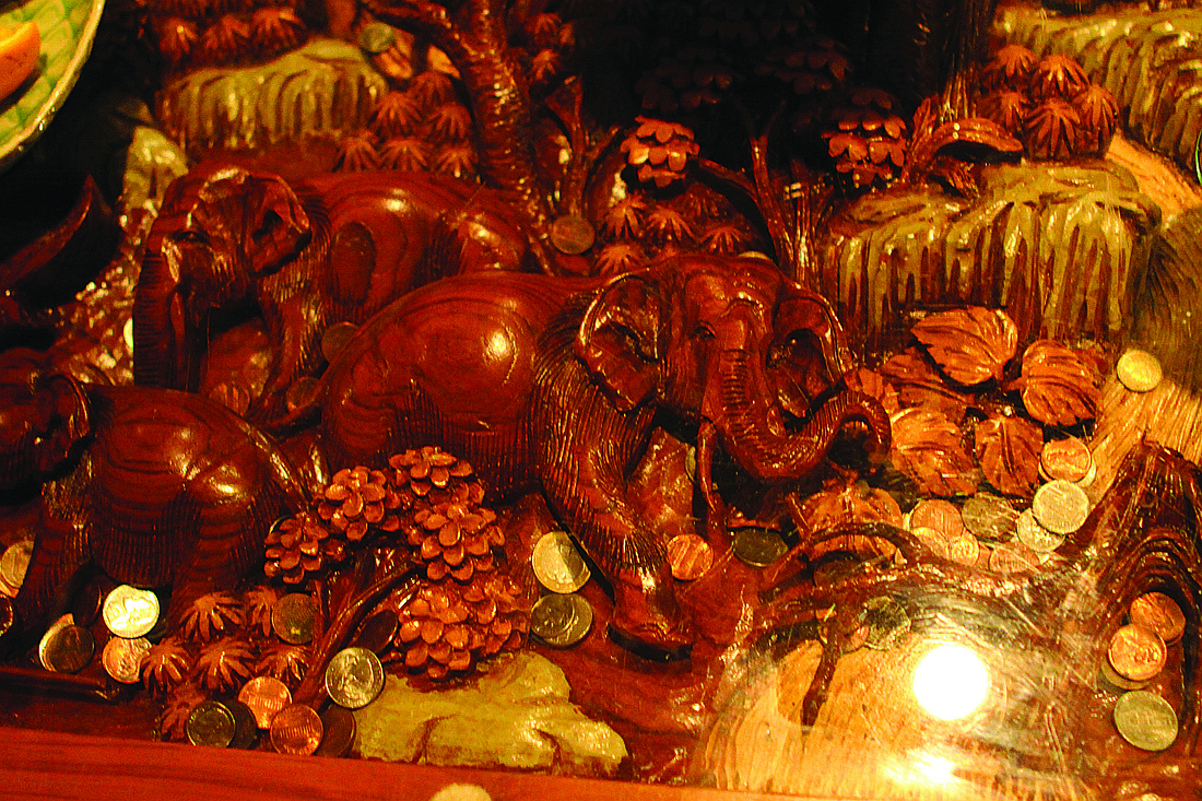 The animals, carved into 20 tables at the restaurant, hail from Thailand.
