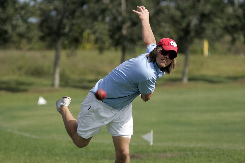 Bowler Justin Harris warms up before his team takes the field.