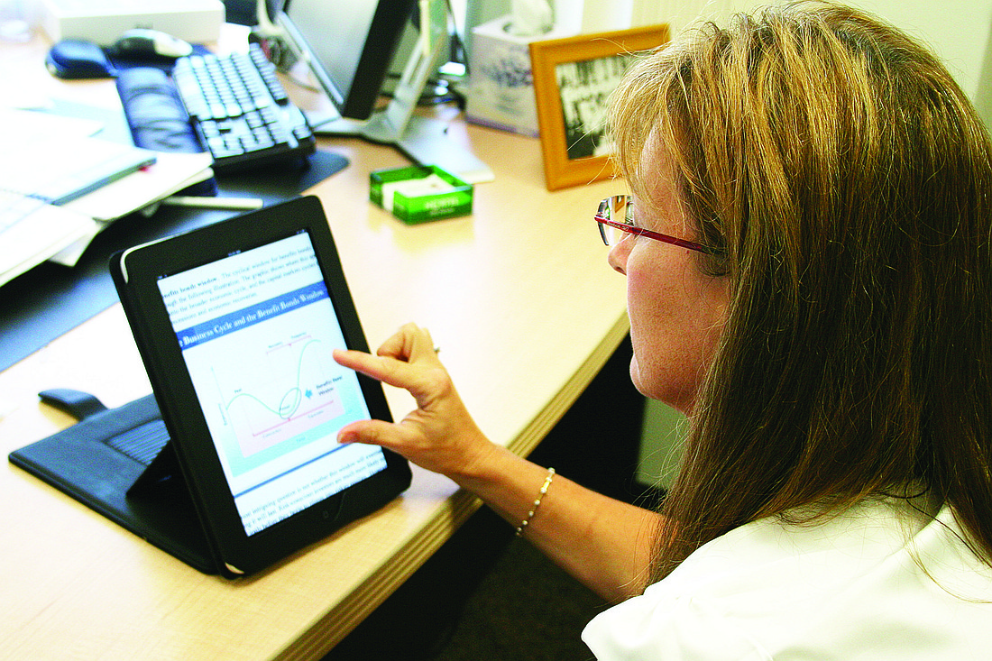 Management Information Systems Director Kathi Pletzke uses the test iPad.