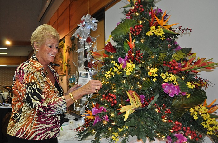 Debbie Comer admires one of the trees up for grabs in the silent auction.