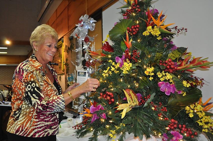 Debbie Comer admires one of the trees up for grabs in the silent auction.
