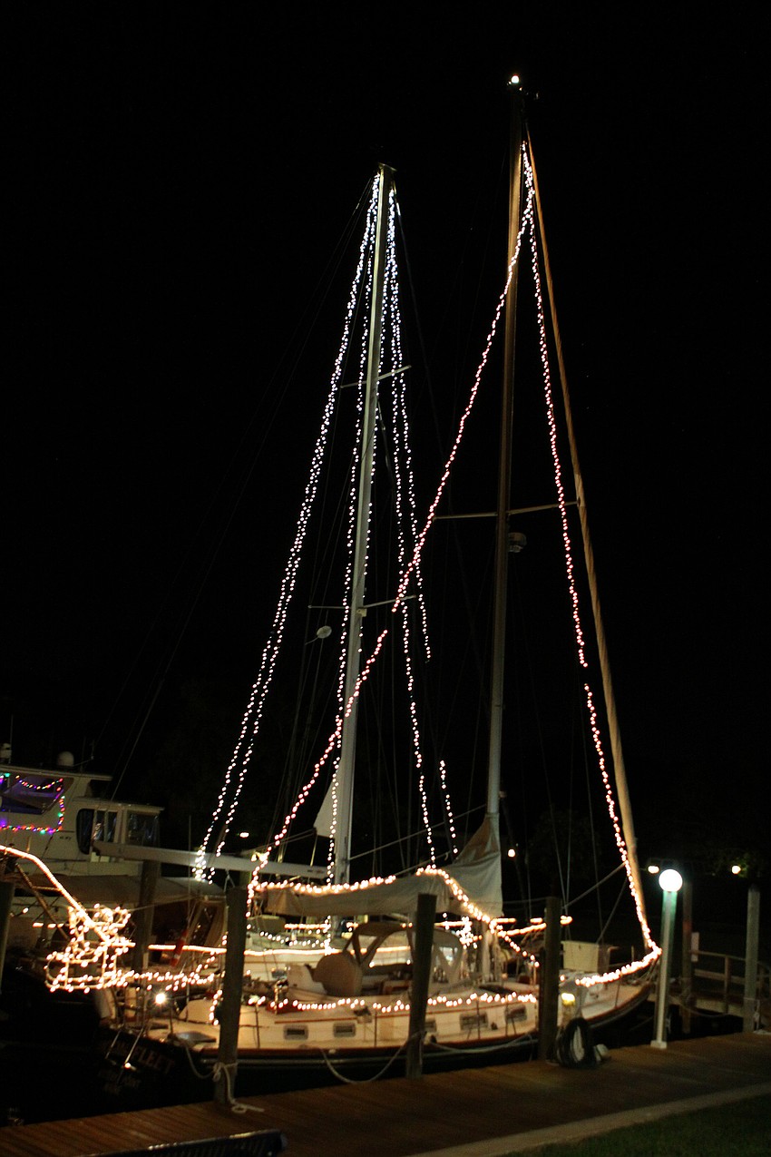 Two sailboats light up the docks at Bird Key Yacht Club.