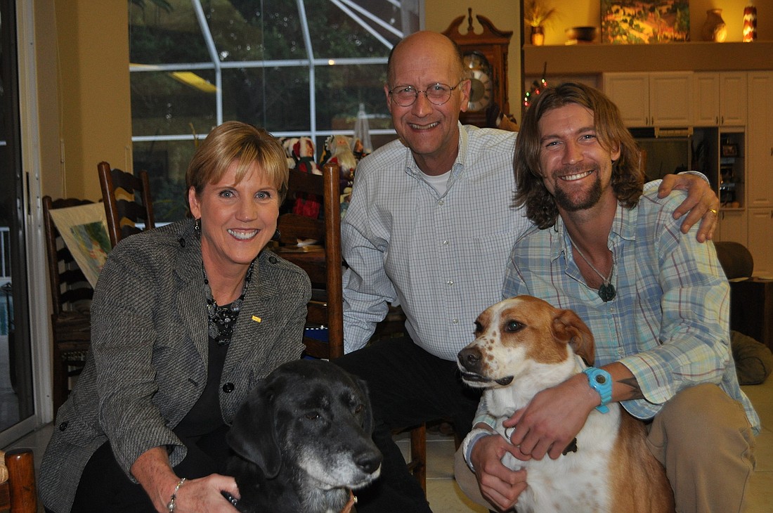 "We teach the kids that we've been blessed, so we try to give back," says Margaret Callihan, pictured with her husband, Matt, son Phil, and their two dogs, Lou and Nala.