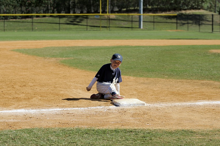 Eight-year-old Aulden St. Lawrence celebrated his Rookie Division Championship by continually rounding the bases long after his teammates had left the ballpark.