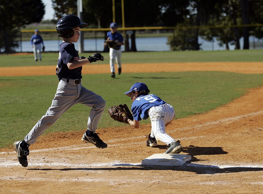 Nine-year-old first baseman Dalton Willis keeps his Red Sox opponent from reaching base