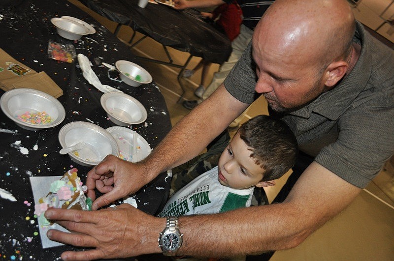 Chad Terrel helped his 4-year-old son, Colten, decorate his gingerbread house, as did Coltenâ€™s sister, Kylie, not pictured.