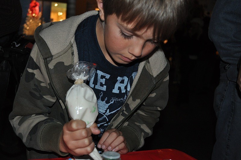 Austin Rohring, 8, eagerly decorated his sugar cookie.