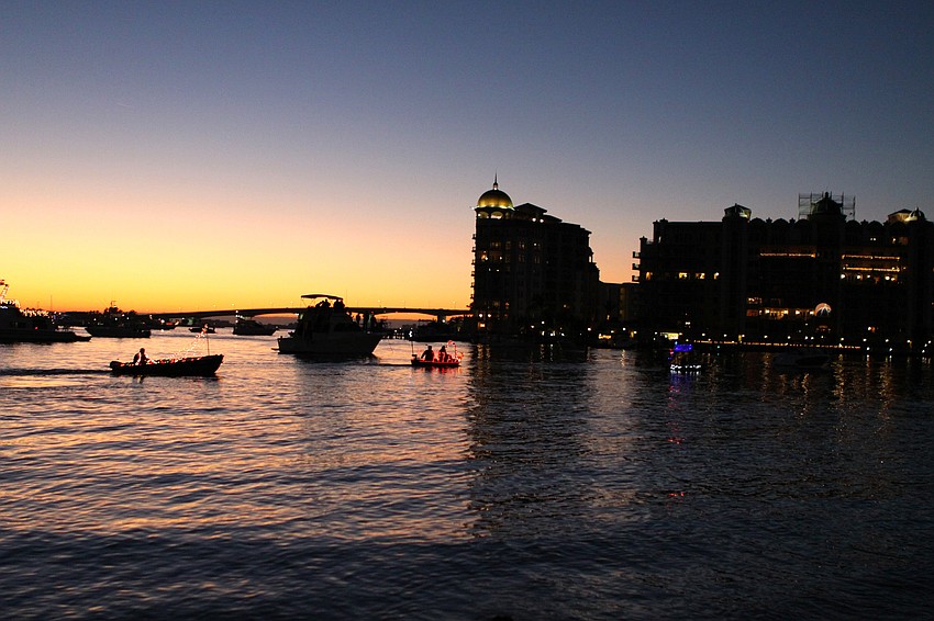 The dinghy paradeâ€™s backdrop included the Ringling Bridge and the skyline of Sarasota at sunset.
