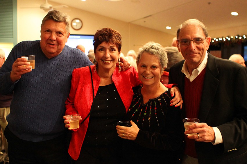 Robert and Sandy Endres raise their glasses with their friends Sally and Terry Kall.