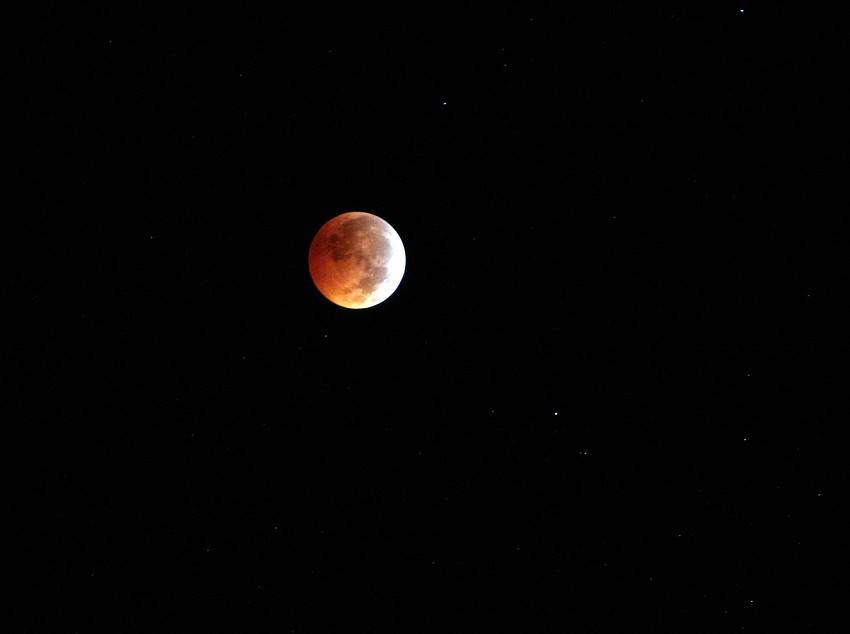 During a total lunar eclipse, the full moon passes behind the Earth, which blocks the sun's rays from hitting the moon.