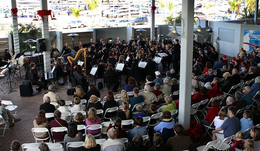 The Sarasota Orchestra performed to a large crowd in the courtyard of Mote Aquarium on Tuesday, Dec. 21.