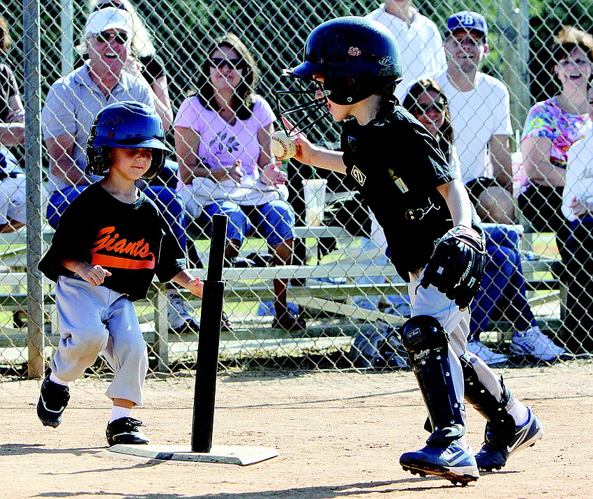 Giants' player Caleb Rumble tried to outrun Pirates' catcher Jameson Syprett to home plate during their final T-ball game of the season in November.