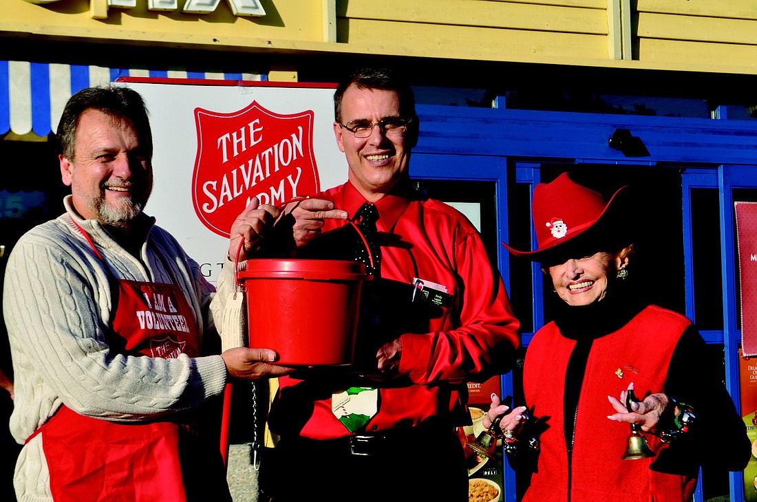 With David Sutton, of The Salvation Army, making the final kettle collection on Christmas Eve are Publix Manager Andy Lappin and dedicated bell ringer Edith Barr Dunn.