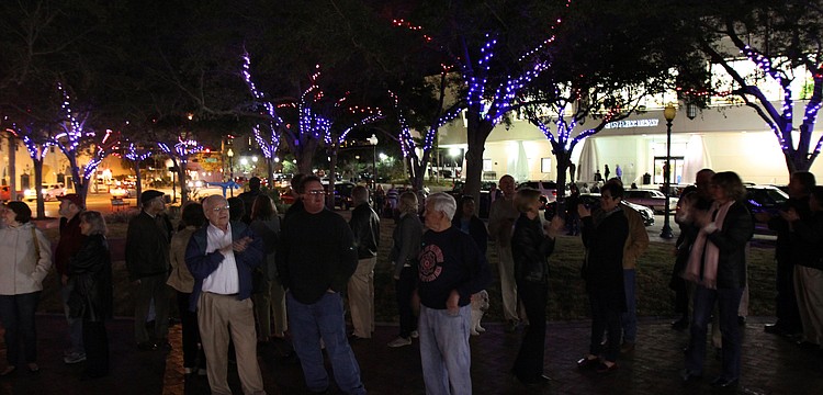 The crowd takes in the first view of the Five Points Selby Park LED tree lighting system.