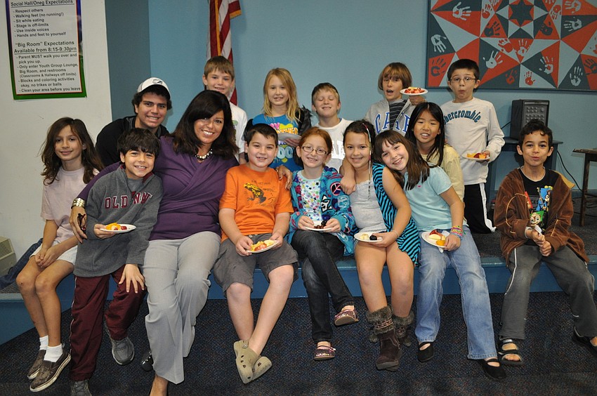 The students are all smiles with Sabrina Silverberg, Director of Religious Education at Temple Emanu-El.