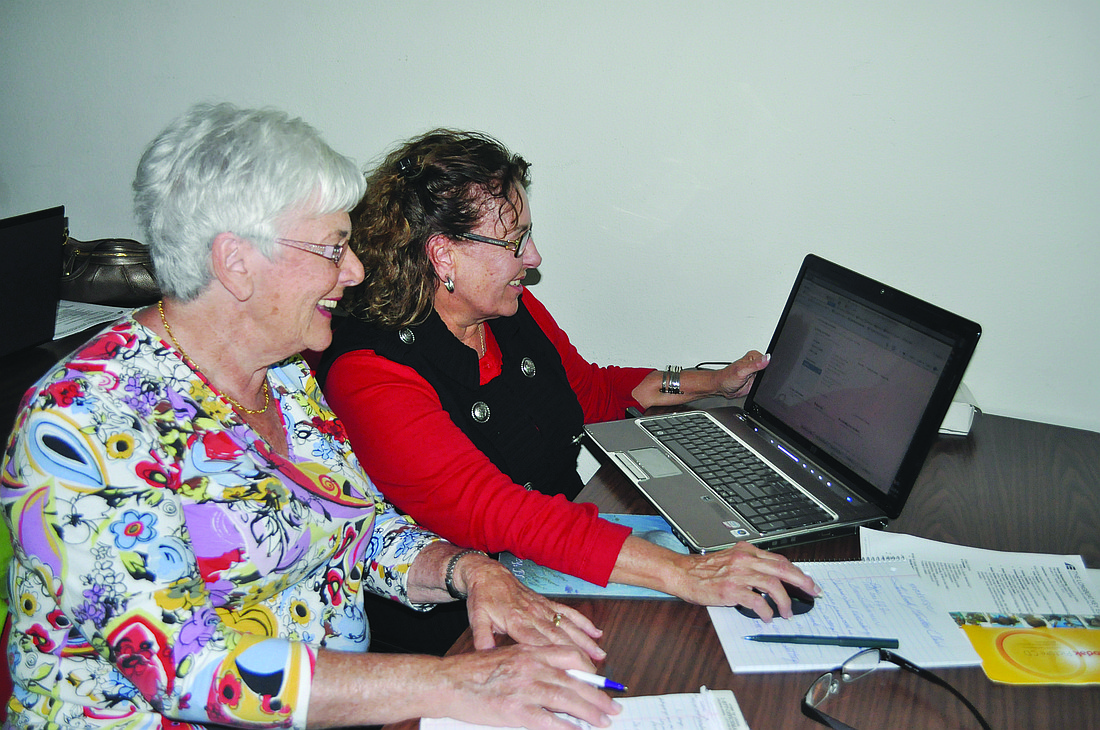 Bette Balk and Carole Zicherman work on their Facebook pages at "Social Networking 101: Facebook and Twitter" Jan. 6, at the Education Center.