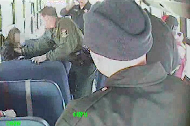 Surveillance tape shows Dep. Mark Perrin grabbing a teenage girl and throwing her out of her seat.