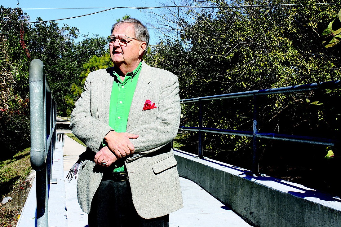 Don Hughes stands atop the pedestrian bridge that links two Gulf Gate neighborhoods. Hughes believes the bridge brought vandalism into his neighborhood.