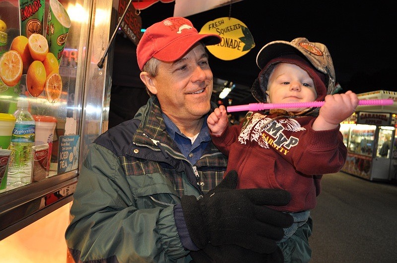 Caleb Baker, 10 months, thoroughly enjoyed playing with a straw, much to the amusement of his grandfather, Phill.
