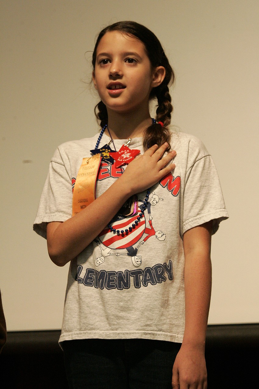 Third-grader Mackenzie Ramalho helped lead the students in the Pledge of Allegiance.