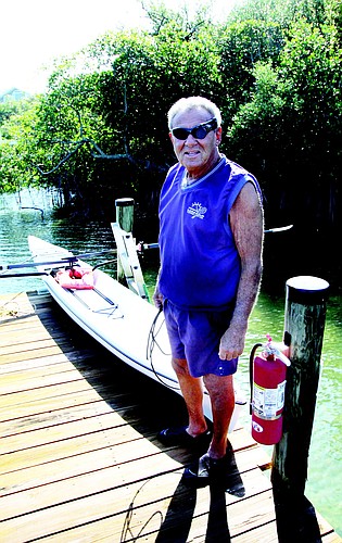 John Crimaldi on the dock behind Whitney Beach with his rowing shell