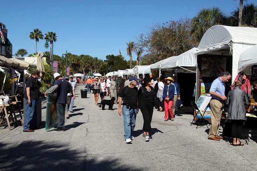 People enjoy the weather and the art on Saturday, Jan. 29 at St. Armand's Art Fair.