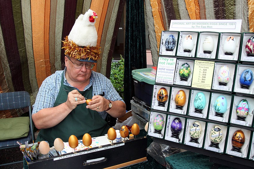 The Egg Man, Alan Traynor, works on painting some solid wood eggs during the 17th annual Siesta Key Craft Festival Saturday, Feb. 5, in Siesta Key Village.