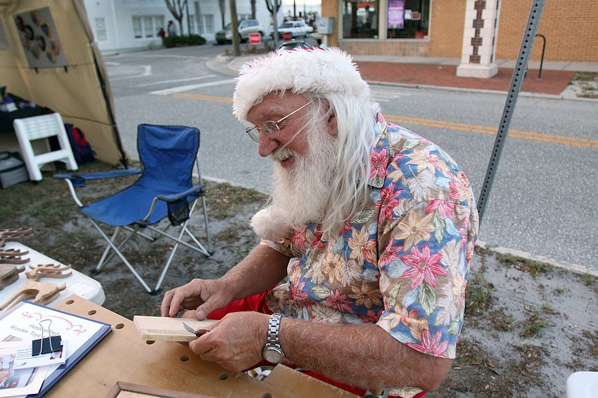 Santa the Toymaker works on making a jewelry box during Rosemary Rising.