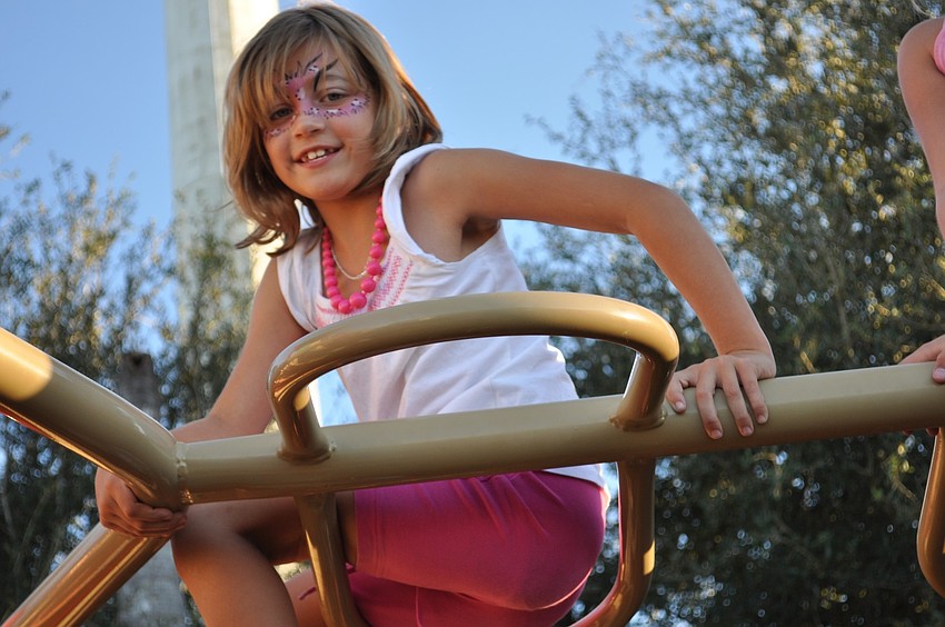 Haylee Miller, 9, found a perch atop the monkey bars.