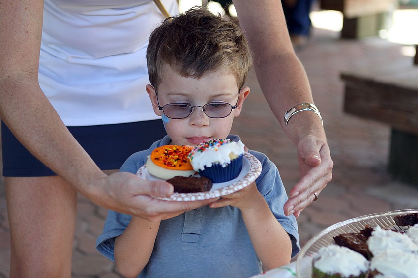 Lawson Francis looks at the goodies he has picked out at the birthday party for S.O.S.