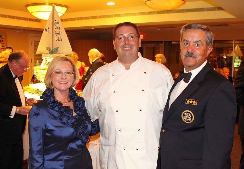 Barbara Sanandres and Commodore Louis Sanandres pose with executive chef Joe Santangini in front of the boat ice sculpture that Santangini created especially for Commodore Sanandres.