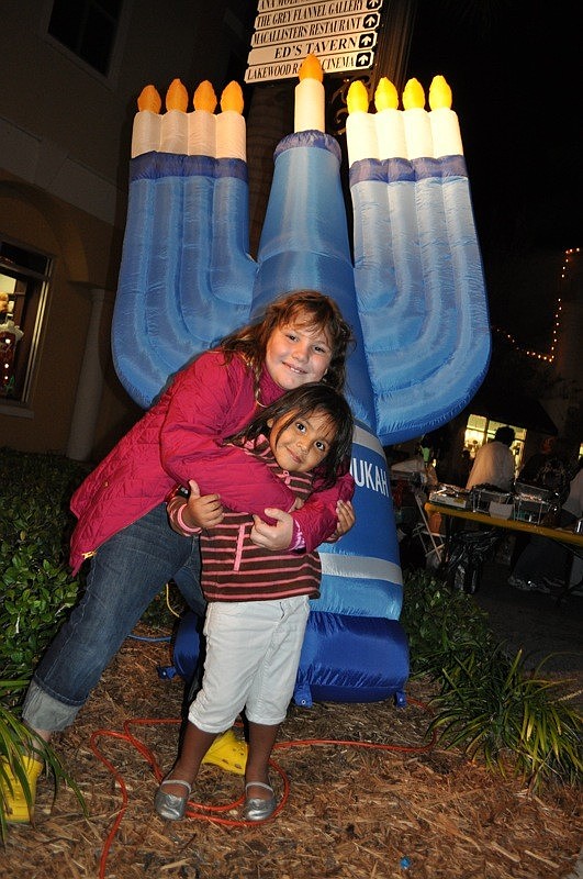 Rebekah Spiegelman, 8, and her sister Reina made sure to get a picture in front of the inflatable Menorah.