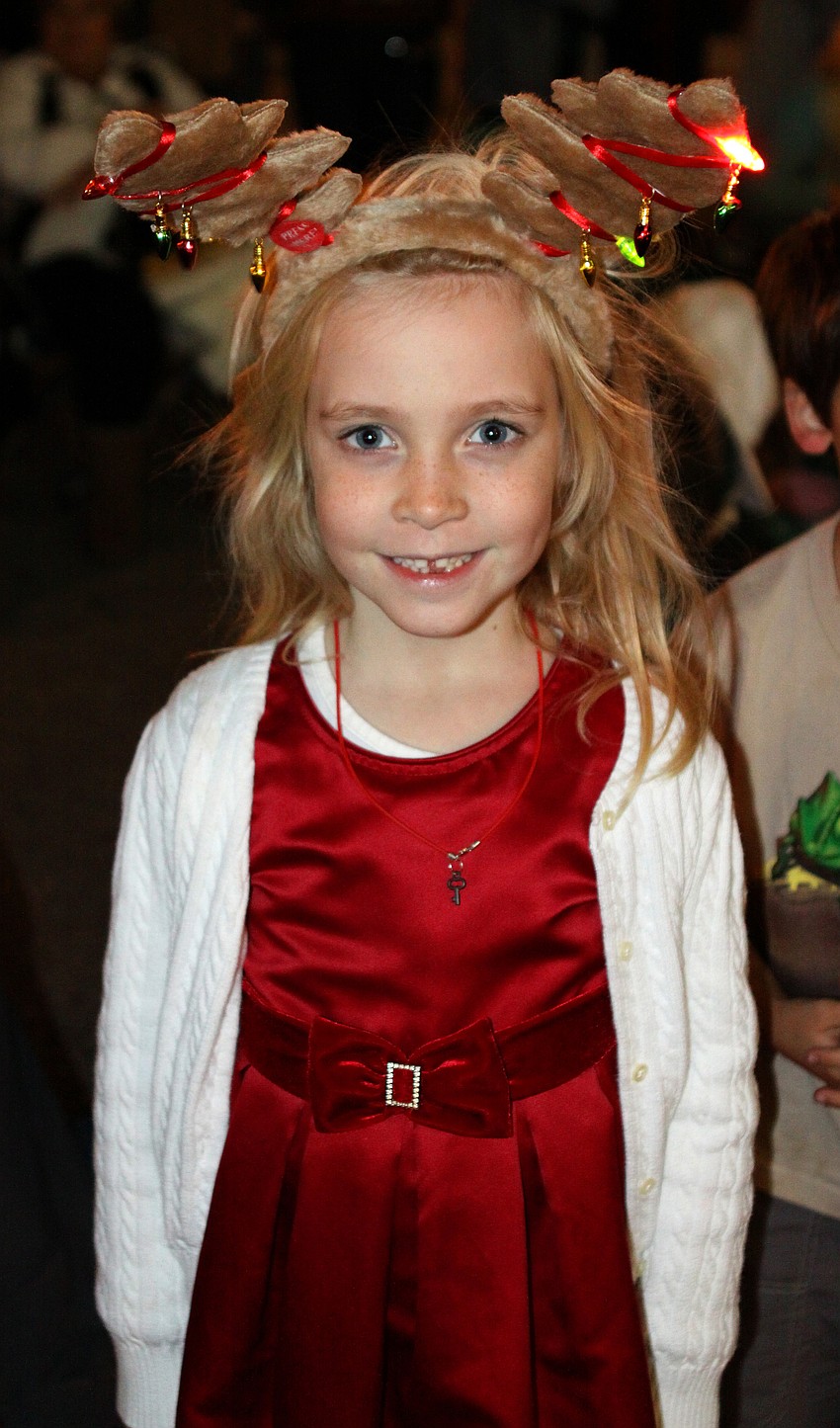 Abigail Koester wears reindeer ears that light up while she watched the parade on Main street on Saturday, Dec. 4.