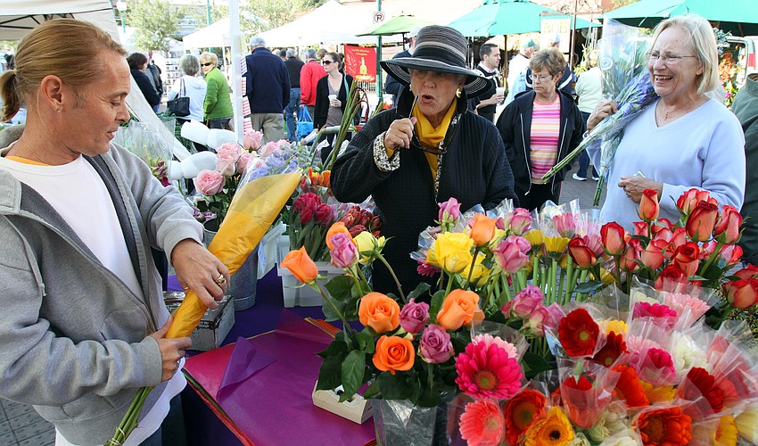 Bill Malvers sells some beautiful flowers to Nancy Schlossberg.