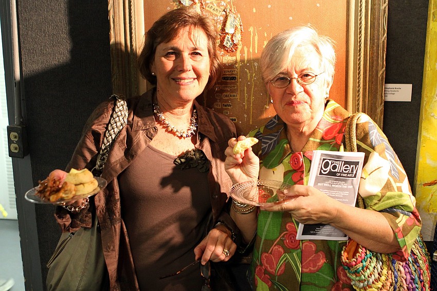 Marcia Babyak and Pat Knittel enjoy some food Thursday, Feb. 11 at the opening night of the Fabulous Arts Boutique.