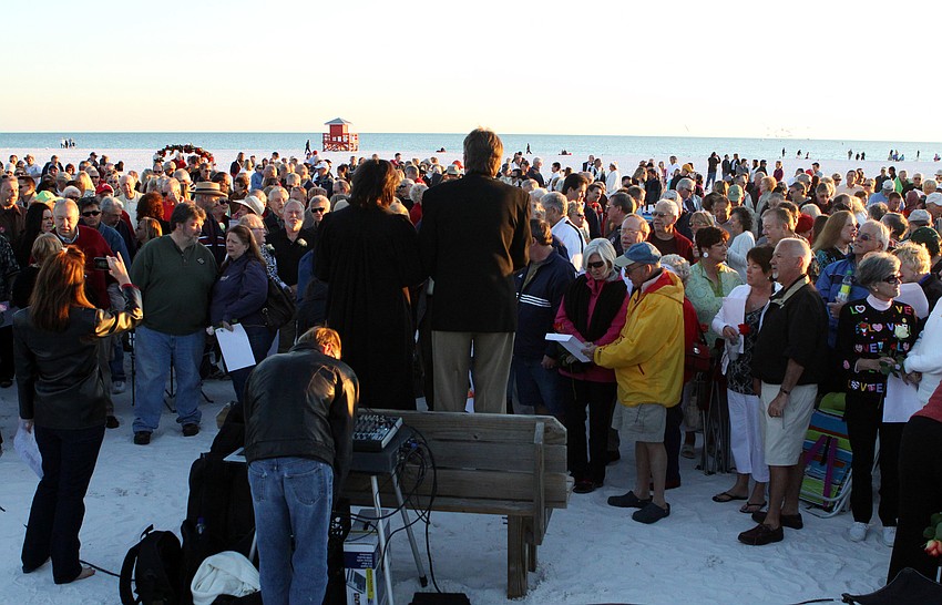 The crowd listens to Judge Becky Titus as she conducts the Say I Do, Again ceremony, Monday, Feb. 14 on Siesta Key Beach.