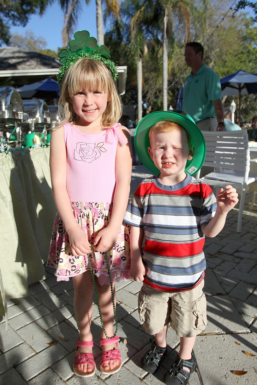 Hadley, 4 1/2, and Chase, 2 1/2, Middleton have fun wearing Irish crowns and hats on Thursday, March 17 at Longboat Key Club's outdoor Harbourside dining patio.
