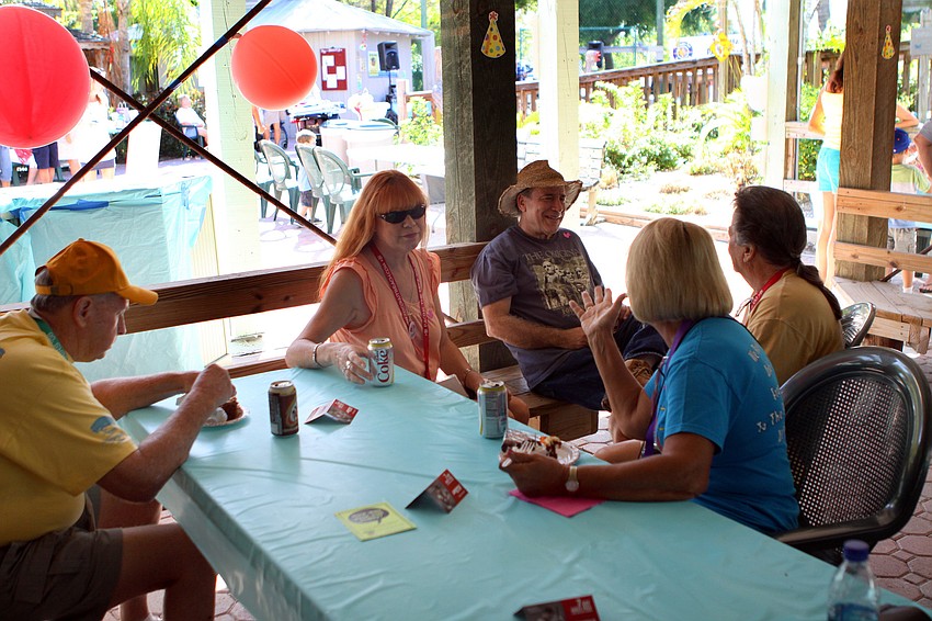 People enjoy chatting and eating while attending the second birthday for Save Our Seabirds.