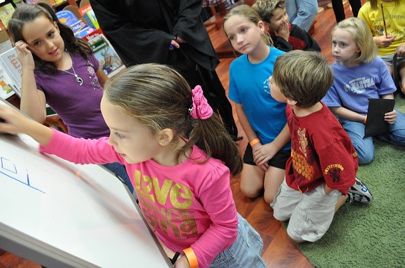 Daniella Villarreal, front, with her sister, Regina, took a stab at Harry Potter Pictionary.