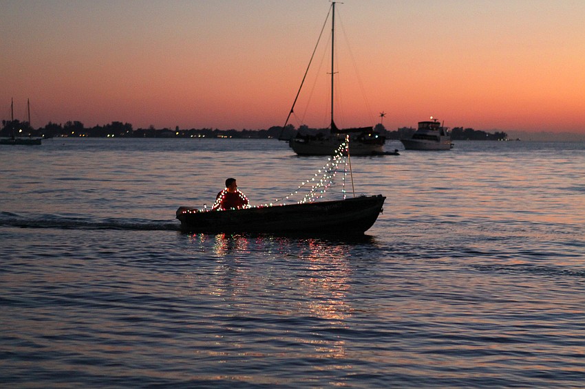 One man ran out of room for his lights so he decorated himself for the dinghy parade.