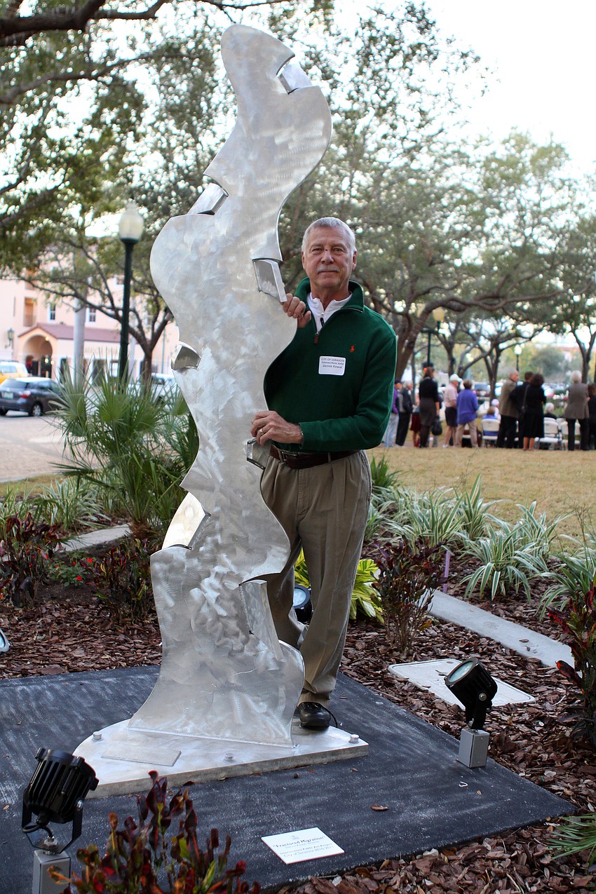 Local artist, Dennis Kowal, poses with his piece, â€œFractured Migrationâ€, which is located in Selby Five Points Park. Many people refer to Kowalâ€™s piece as the â€œice sculptureâ€ since it looks like it is made out of ice.