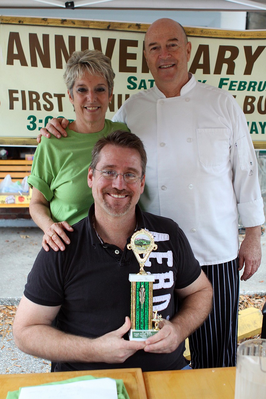 Maggie and Marty Glucklich pose with winner Dr. Patrick Dower after the Veg's First Annual Veggie Burger Eating Contest on Saturday, Feb. 5 outside of Veg.