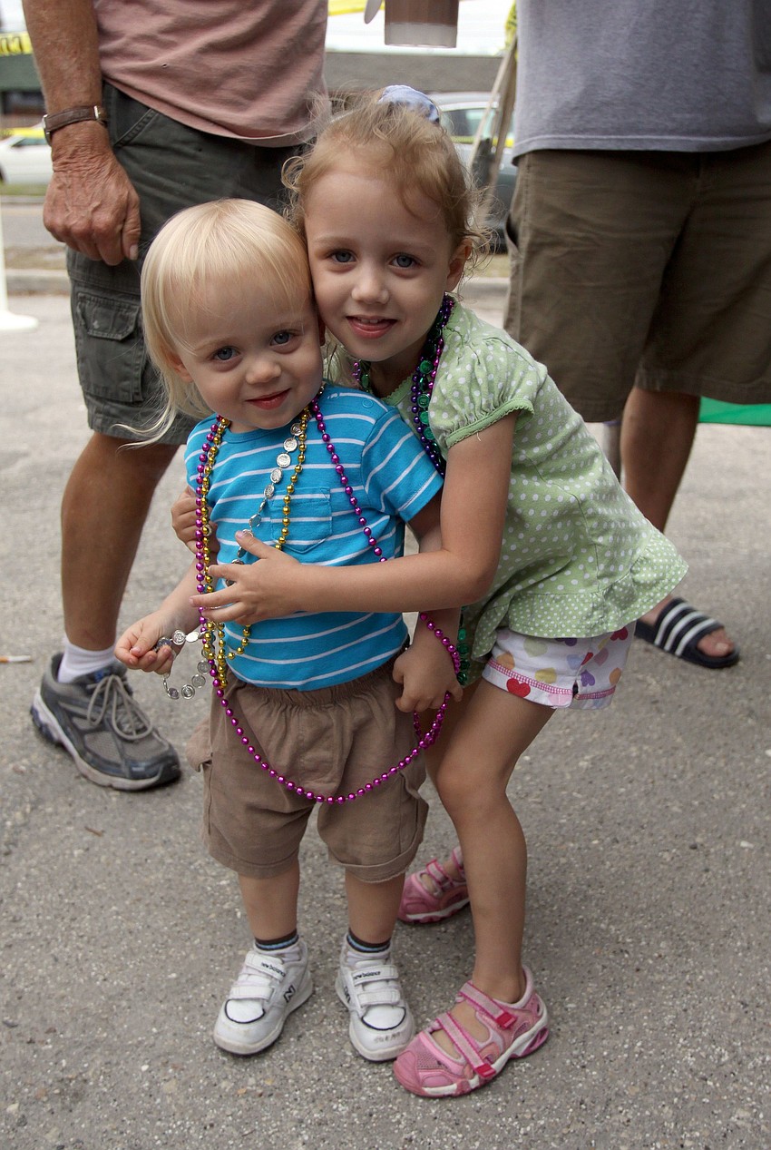 Jack, 20 mos., and Evelyn Saxton, 3, get together for a picture while wearing their beads on Sunday, March 6 during the 1st Annual Sarasota Mardi Gras that was held at Voocaray in Gulf Gate.